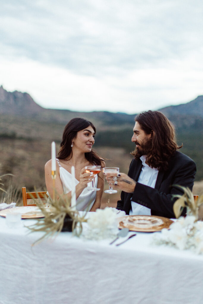 Lovely couple cheers-ing to their nuptials